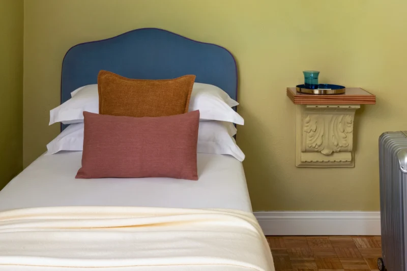 Single room detail with blue headboard, premium bedding and welcoming atmosphere in the heart of Rome - Hotel City Palazzo dei Cardinali, BZAR hotels in Rome
